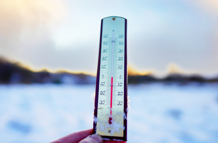 Winter Day Featuring a Thermometer Showing Freezing Temperatures in Snowy Landscape at Sunrise, Converting Fahrenheit (F) to Celsius (C)